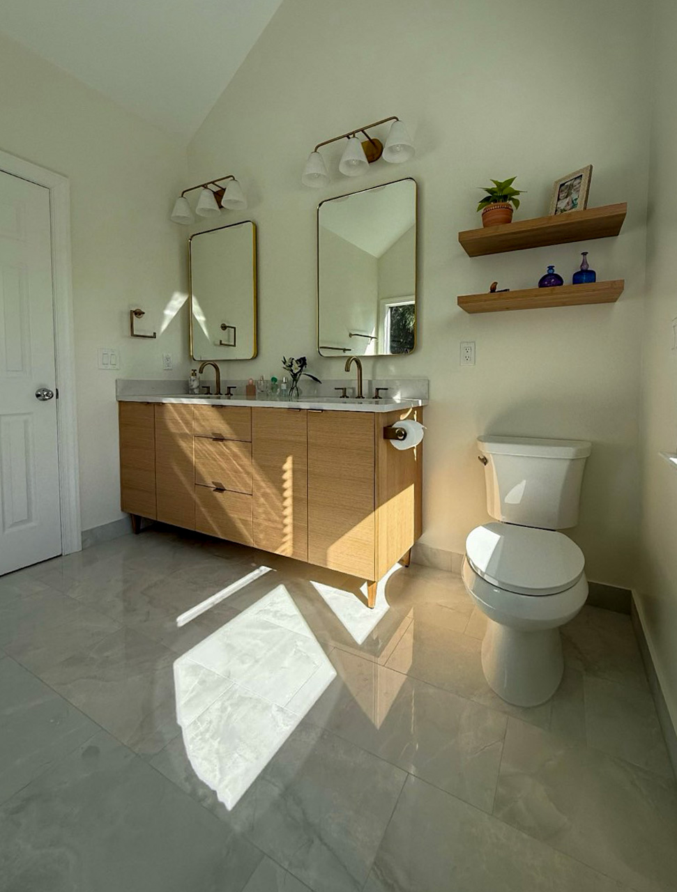 Bathroom remodel with double vanity and floating shelves