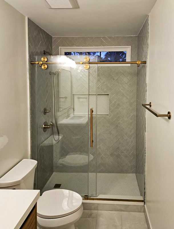 Bathroom remodel with glass shower and brass fixtures