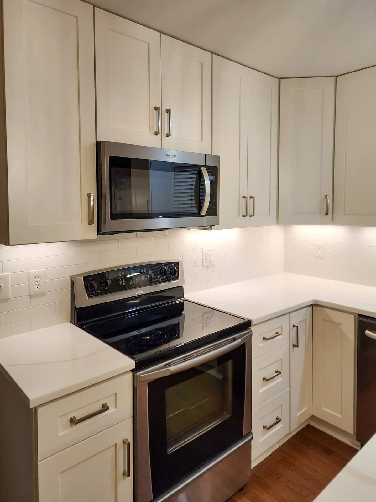 Kitchen remodel upper cabinets with microwave, range, and new countertop