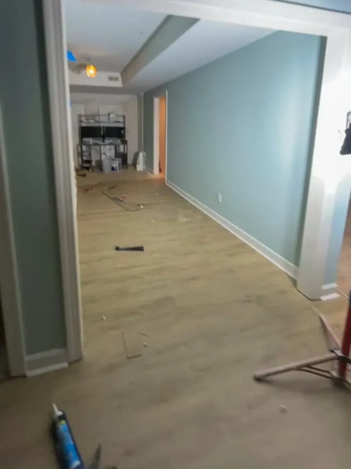 Living room remodel in progress with new flooring and painted walls