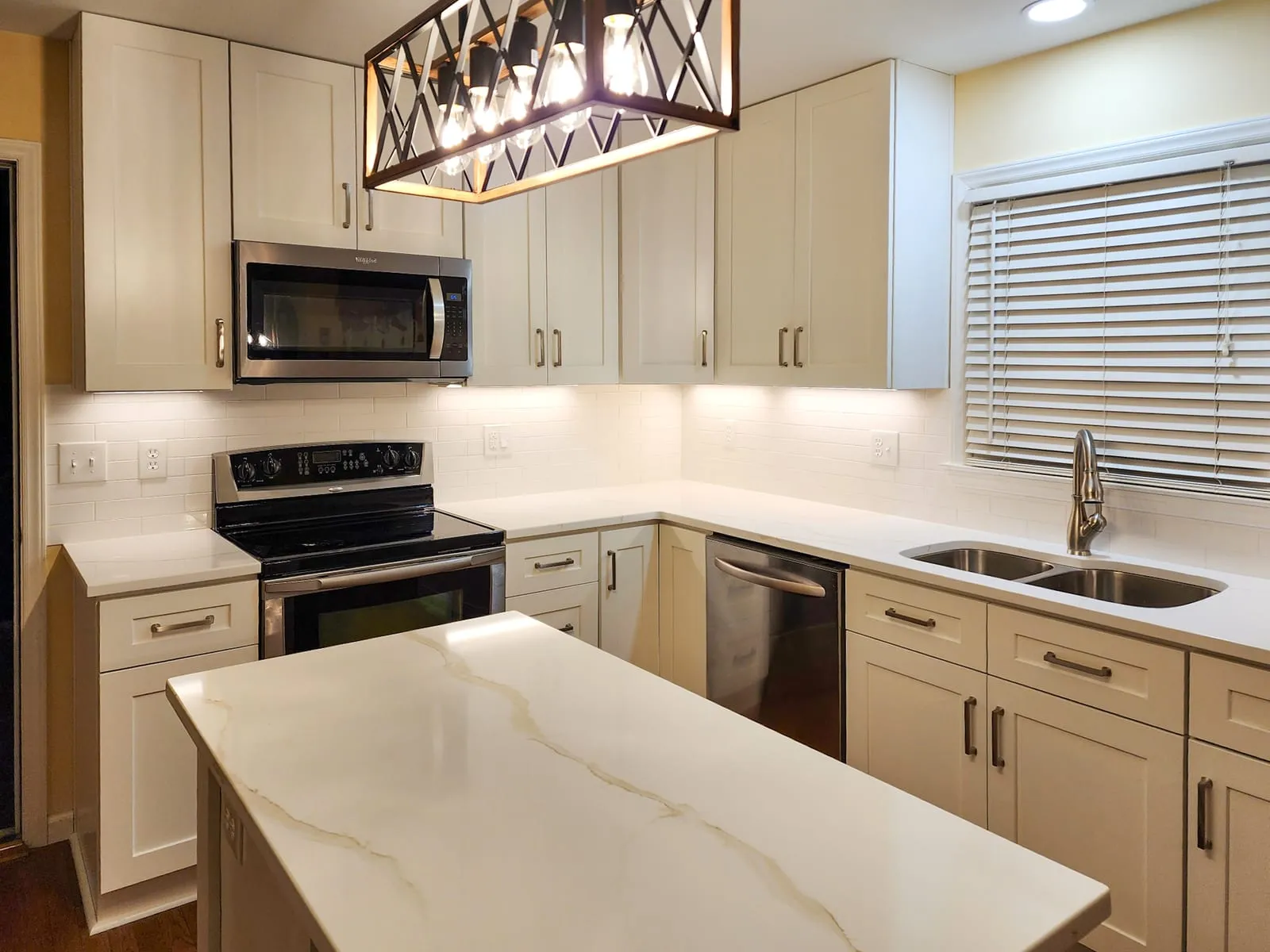 Kitchen range wall close-up with white cabinets and tile backsplash