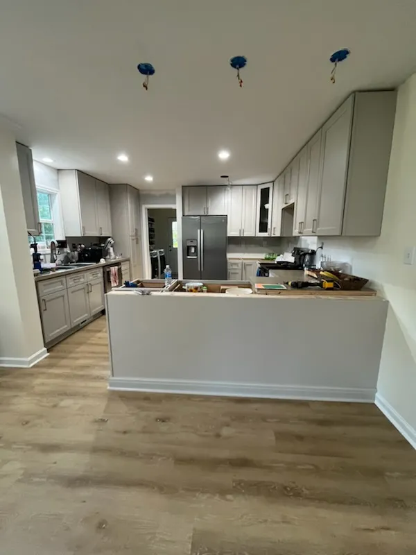 Kitchen remodel with recessed lighting, gray cabinets, and peninsula base