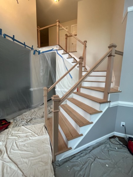 Staircase remodel with refinished wood railing and treads