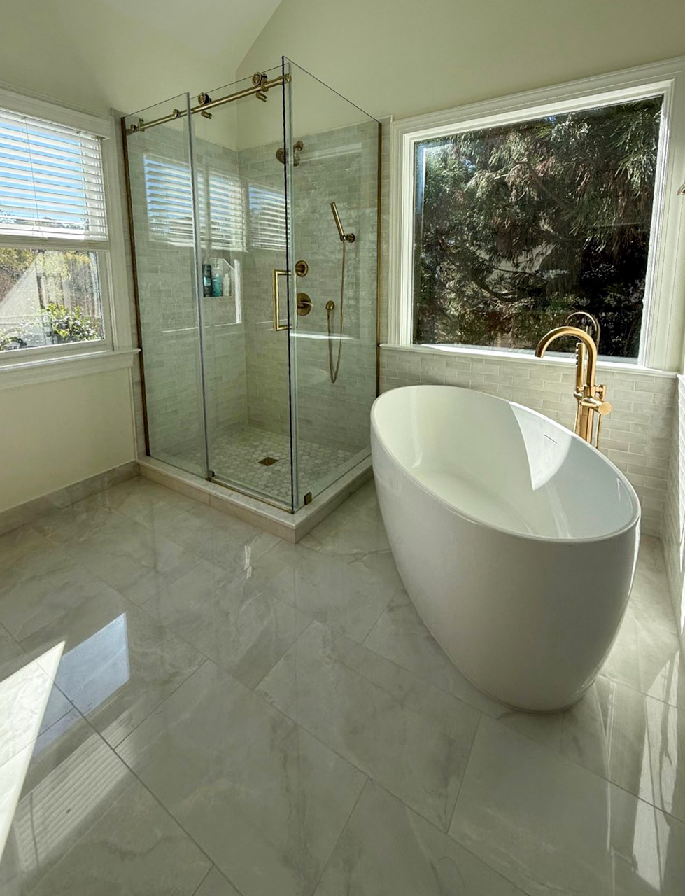 Bathroom remodel with tub window view and glass shower
