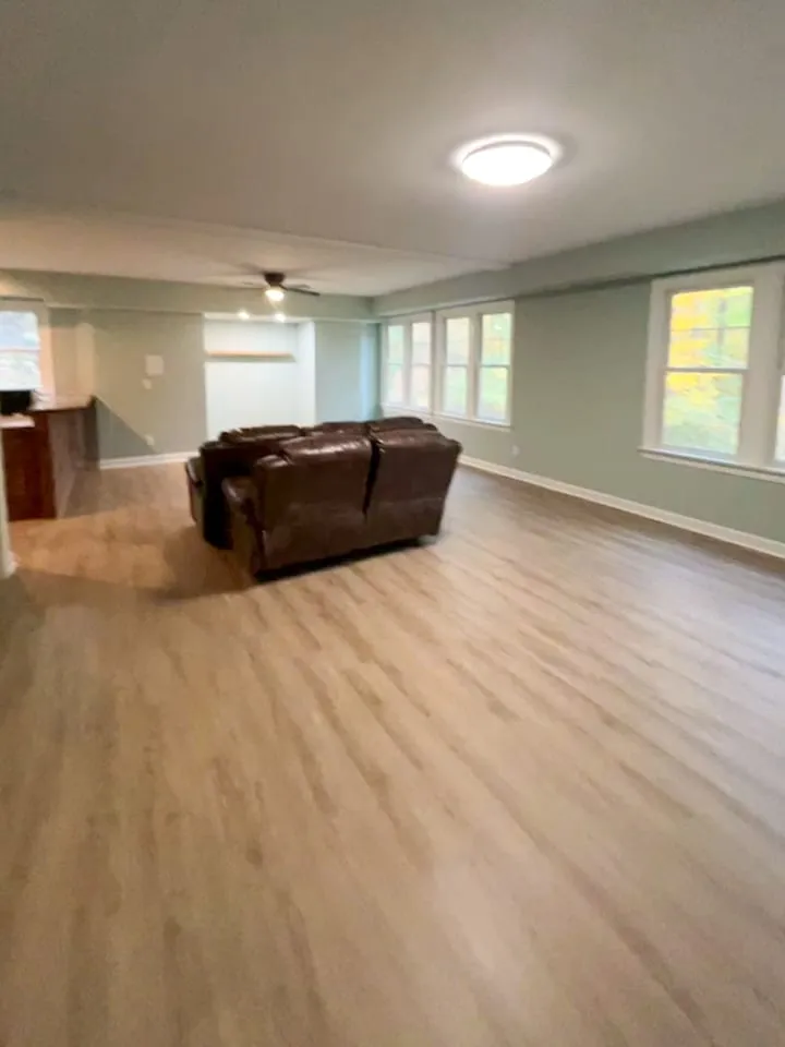 Living room remodel with long window wall, updated flooring, and seating area